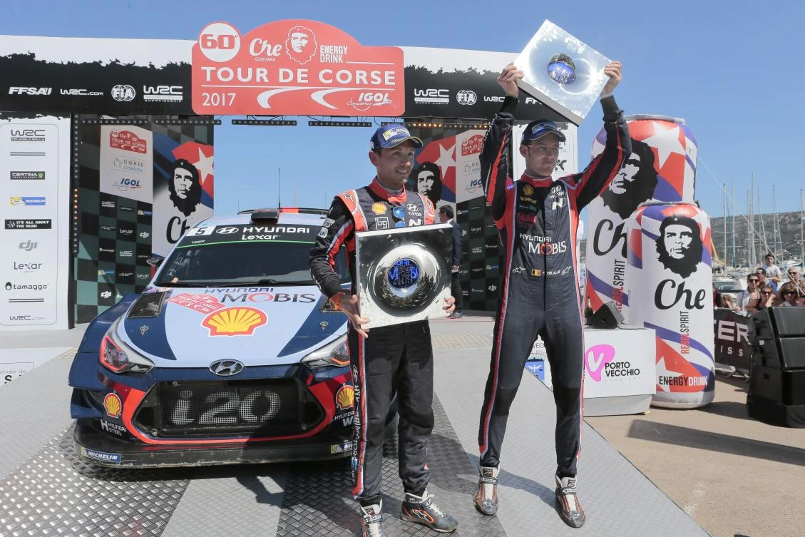 First placed Belgium driver Thierry Neuville, right, and copilot Nicolas Gilsoul celebrate at the end of the Tour de Corse rally, stage of the WRC championships, on Sunday in Porto Vecchio on the French Mediterranean island of Corsica. (AFP)