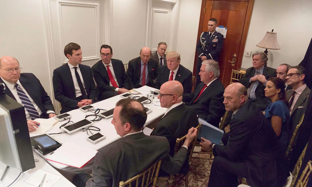 This image released by the White House Press Secretary, Sean Spicer, on Twitter on April 07, 2017 shows President Donald Trump receiving a briefing on the Syria military strike from the National Security team via secure video teleconference on April 06, 2017 at the Mar a Lago estate in West Palm Beach, Florida. (AP)