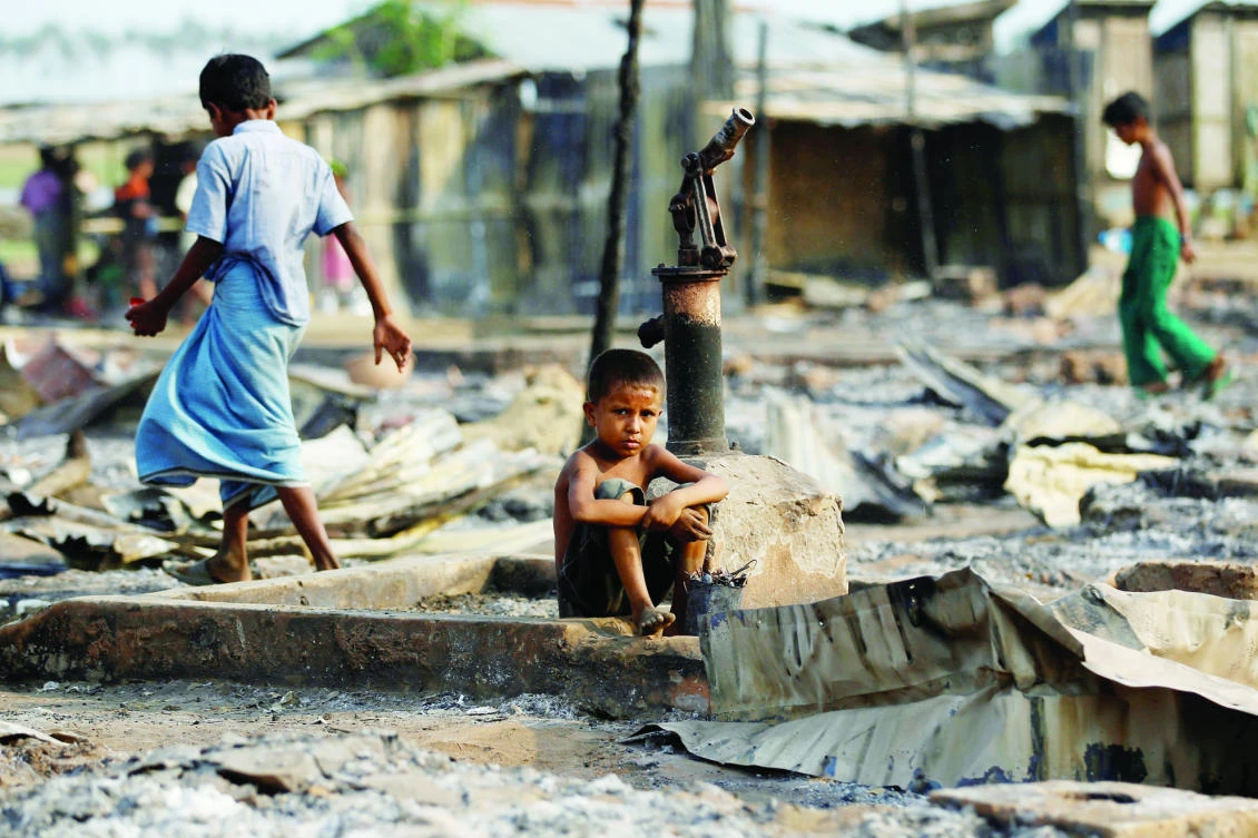 A boy sits in a burned area after fire destroyed shelters at a camp for internally displaced Rohingya Muslims in the western Rakhine state near Sittwe, Myanmar in this May 3, 2016 file photo. (Reuters)