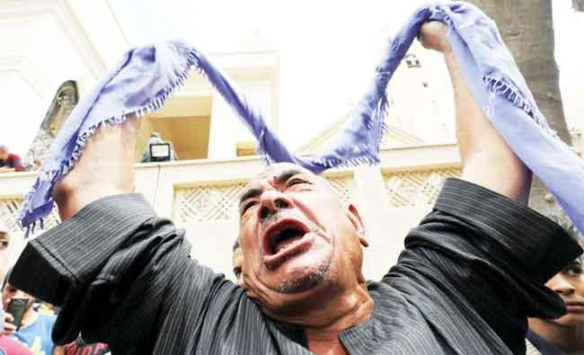 A relative of one of the victims reacts after a church explosion killed dozens in Tanta, Egypt, on Sunday. (Reuters)