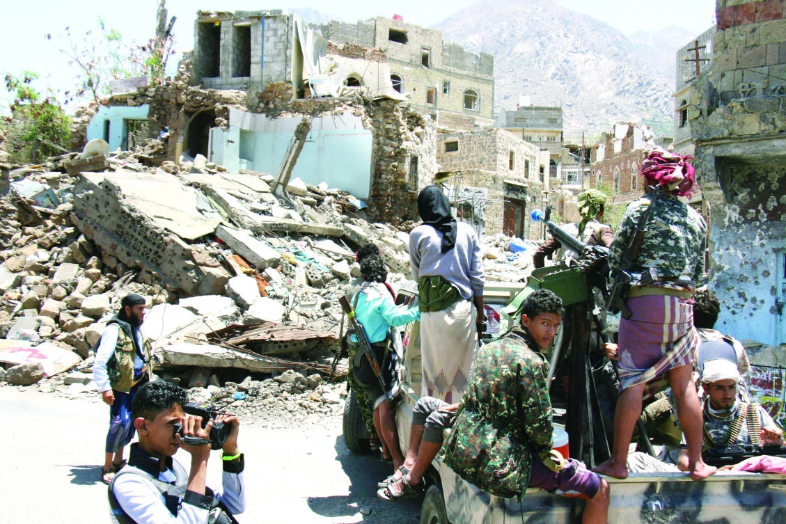 Pro-government tribal fighters patrol a street during a visit by a UN delegation in the war-torn southwestern city of Taiz, Yemen, on Sunday. (Reuters)