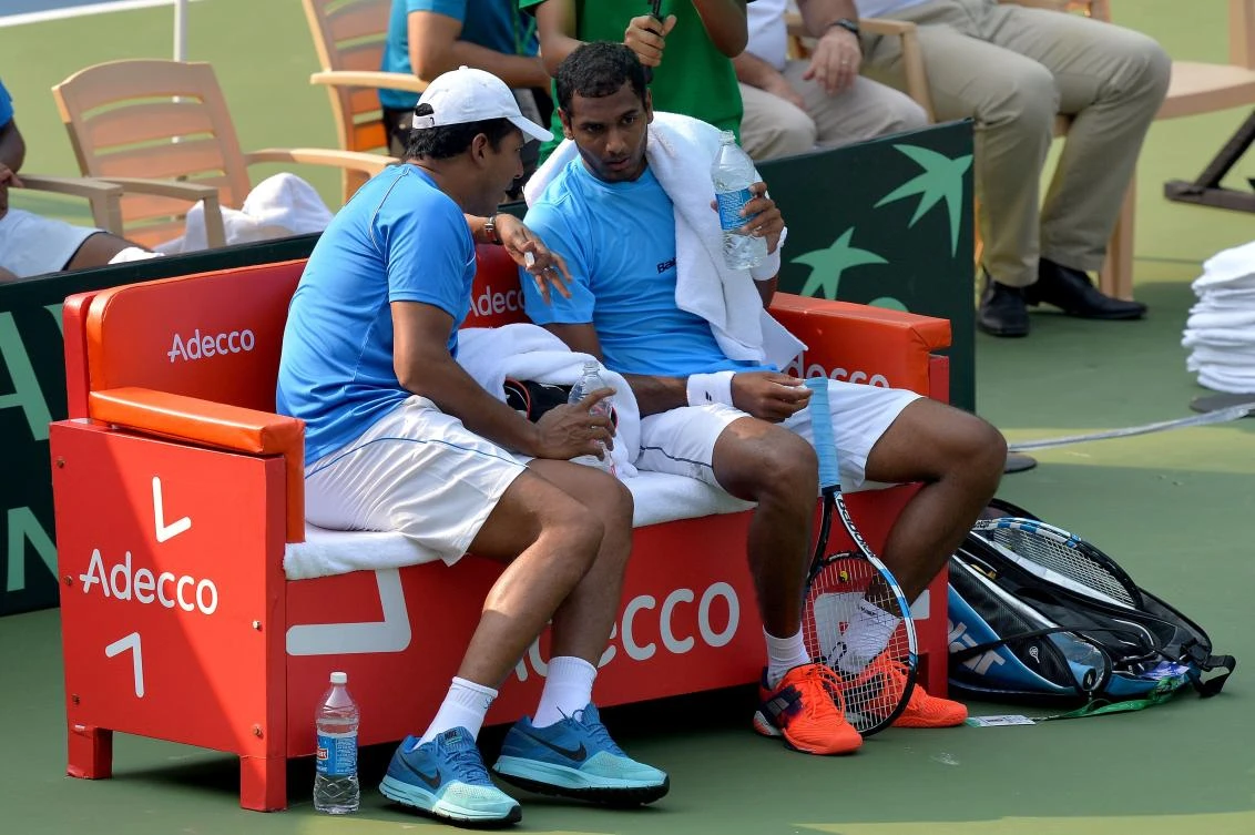 Indian player Ramkumar Ramanathan, right, speaks with his team's non-playing captain Mahesh Bhupathi during a break in his singles match against Uzbekistan's Temur Ismailov at the Davis Cup Asia Oceania group one tie match held between India and Uzbekistan at the Karnataka State Lawn Tennis Association (KSLTA) Stadium, in Bangalore on Friday. (AFP)