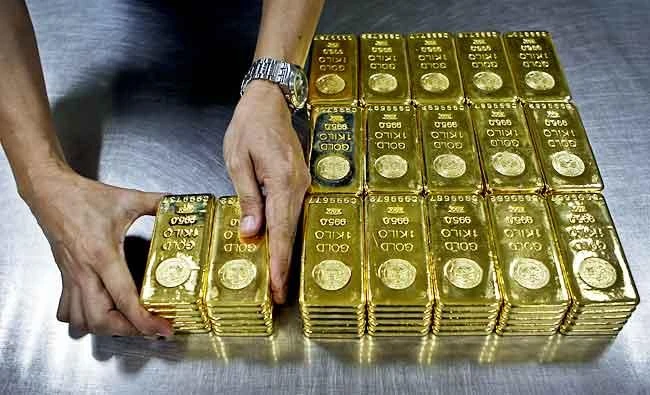 In this file photo, a technician prepares 1 Kg gold bars of 995.0 purity to pack for delivery at the Emirates Gold company in Dubai, United Arab Emirates. (AP)