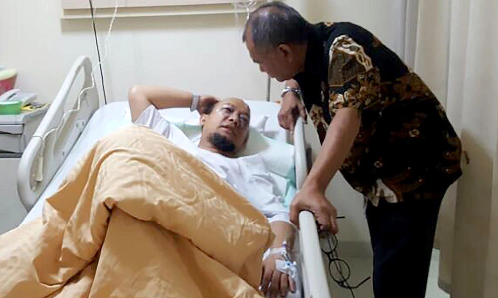 Indonesia's anti-corruption investigator Novel Baswedan (L) talks with Agus Rahardjo (R), chief of the Corruption Eradication Commission (KPK), at a Jakarta hospital where he is confined following an acid attack on Tuesday. (Indonesian police handout via AFP)