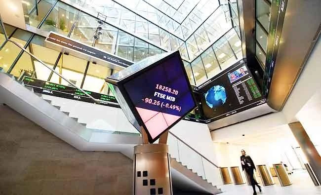 This file photo taken on March 04, 2016 shows a woman as she walks through the central atrium at the London Stock Exchange in central London on March 4, 2016. (AFP)