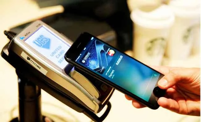 A man uses an iPhone 7 smartphone to demonstrate the mobile payment service Apple Pay at a cafe in Moscow, Russia, in this October 3, 2016 file photo. (REUTERS)