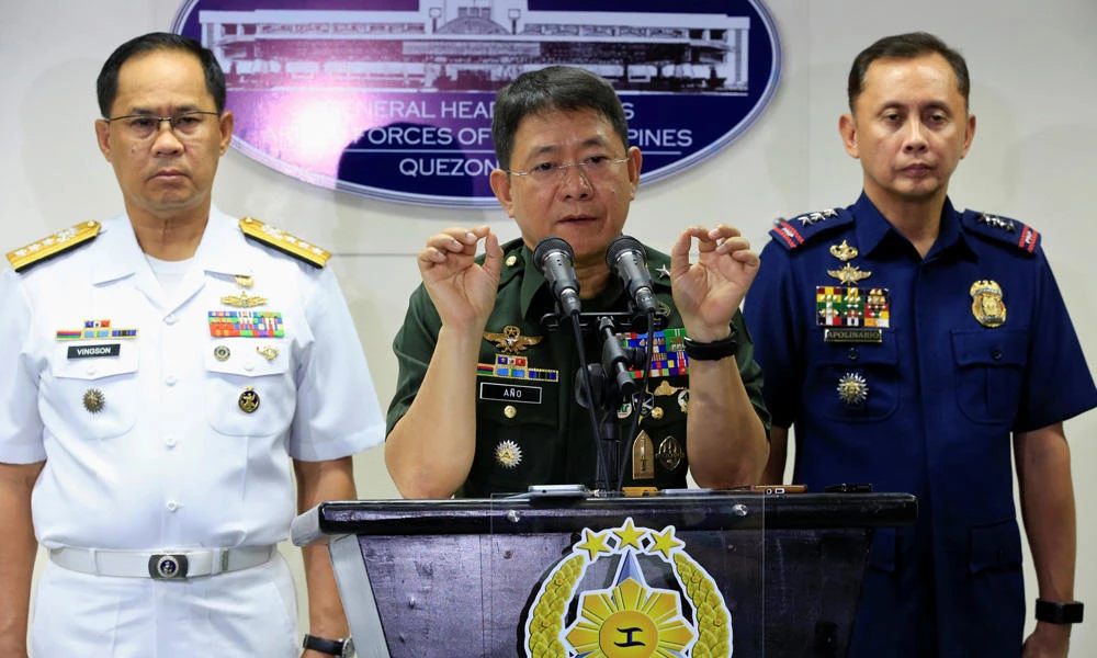 Armed Forces of the Philippines (AFP) Chief of Staff Gen. Eduardo Ano (C) gestures during a news conference inside the military headquarters in Manila on Wednesday. With him are Vice Admiral Narciso Vingson and national police chief Ramon Apolinariio. (REUTERS/Romeo Ranoco)