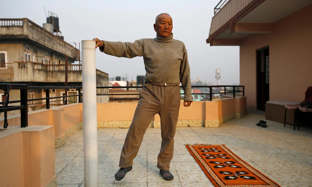 Nepali mountain climber Min Bahadur Sherchan, 85, who will attempt to climb Everest to become the oldest person to conquer the world's highest mountain, performs yoga in Katmandu on Wednesday. (REUTERS/Navesh Chitrakar)