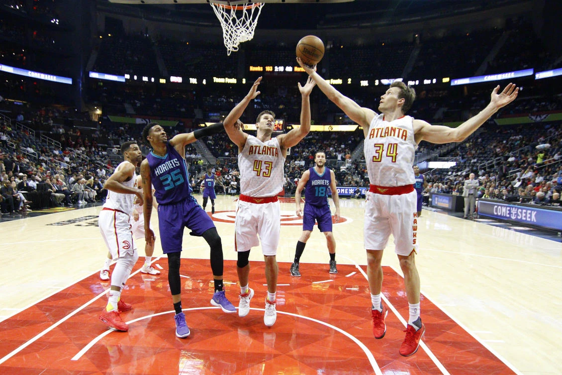 Atlanta Hawks guard Mike Dunleavy (34) grabs a rebound past forward Kris Humphries (43) and Charlotte Hornets forward Christian Wood (35) in the second half at Philips Arena on Tuesday night. (USA TODAY Sports)