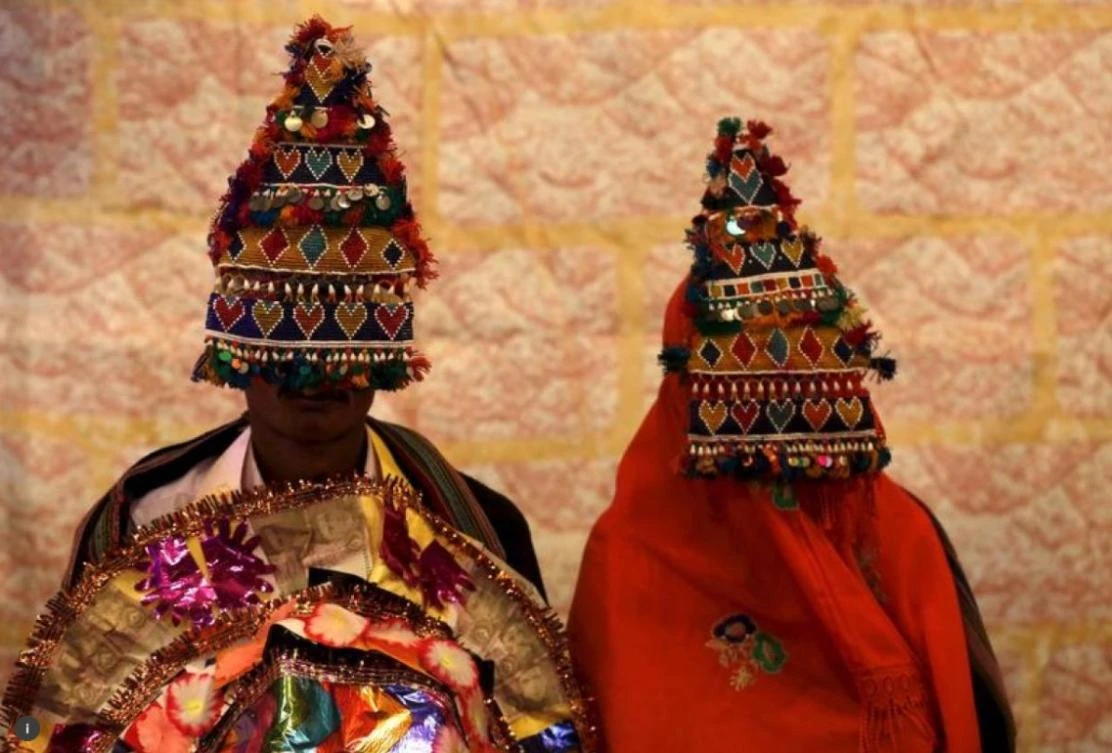 A bride and groom from the Hindu community wait for their wedding to start during a mass marriage ceremony in Karachi, Pakistan, on January 24, 2016. (REUTERS/Akhtar Soomro)