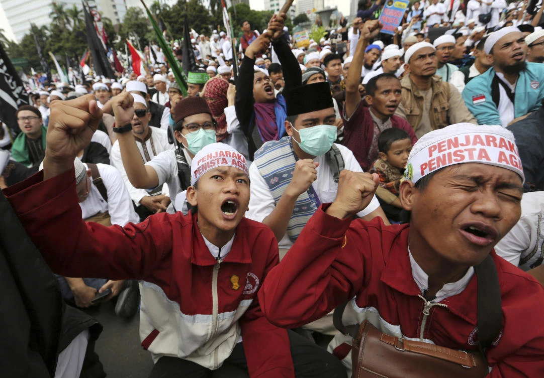 Muslim men shout slogans during a protest against Jakarta's minority Christian Gov. Basuki "Ahok" Tjahaja Purnamain Jakarta, Indonesia. (AP)