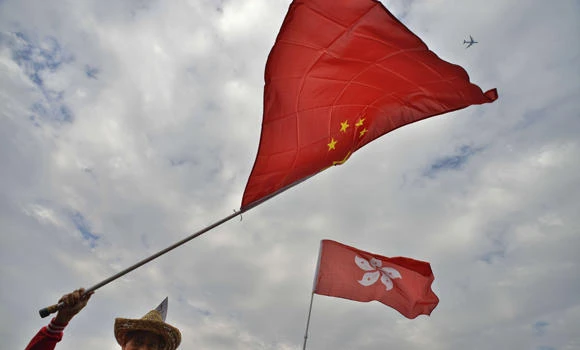 Hong Kong lawmaker charged for upending Chinese flag