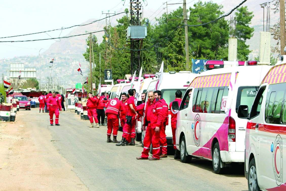 Syrian Red Crescent ambulances stand in wait to enter the besieged rebel-held town Zabadani, northwest
of Damascus, on Wednesday. (AFP)