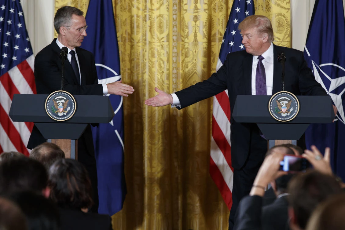 President Donald Trump reaches to shake hands with NATO Secretary General Jens Stoltenberg during a news conference in the East Room of the White House in Washington. (AP)