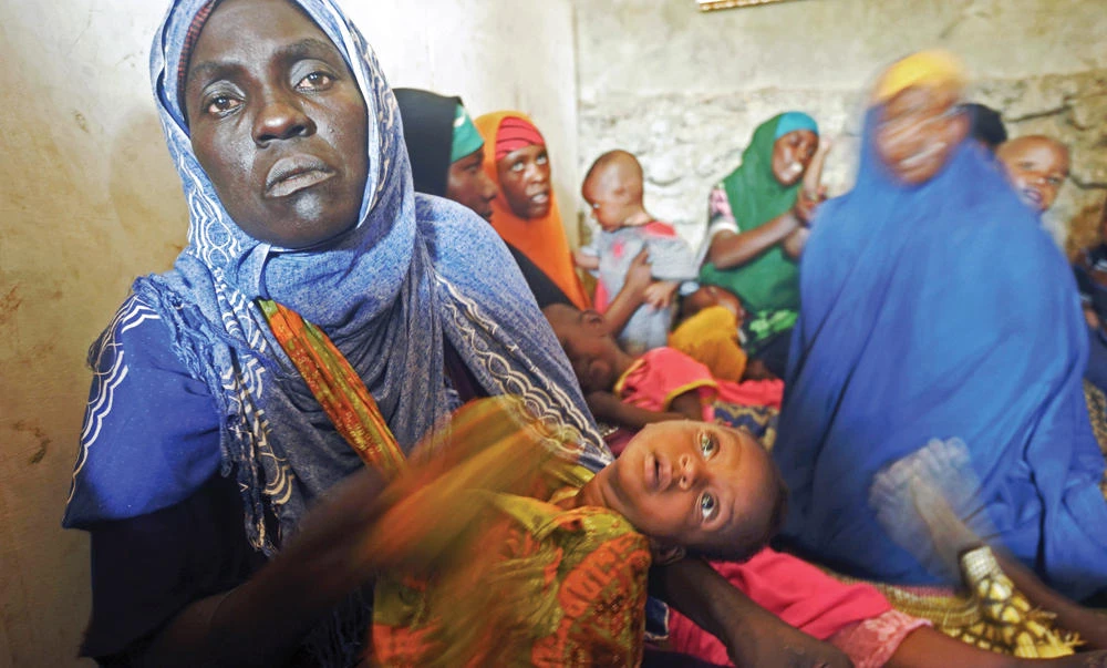 Displaced Somali women with their malnourished children receive medical treatment on the outskirts of Mogadishu on Tuesday. (AFP)