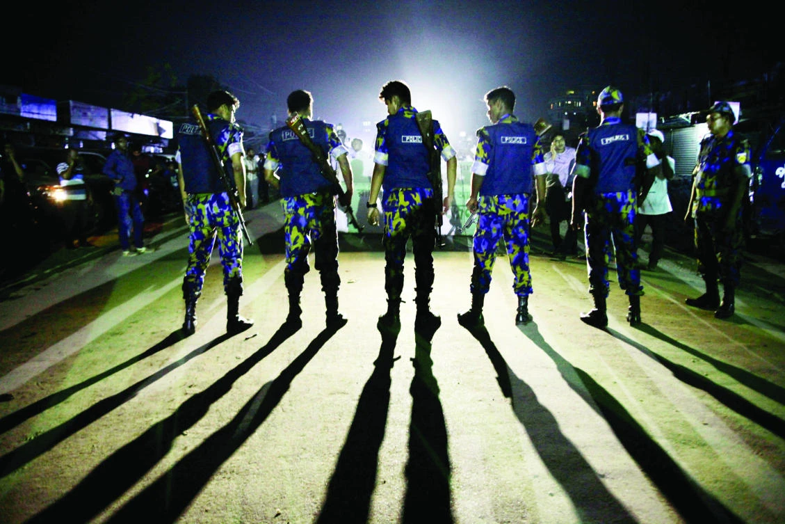 Security personnel block a road outside the Kashimpur jail during the execution of three militants in Dhaka on Thursday. (Reuters)