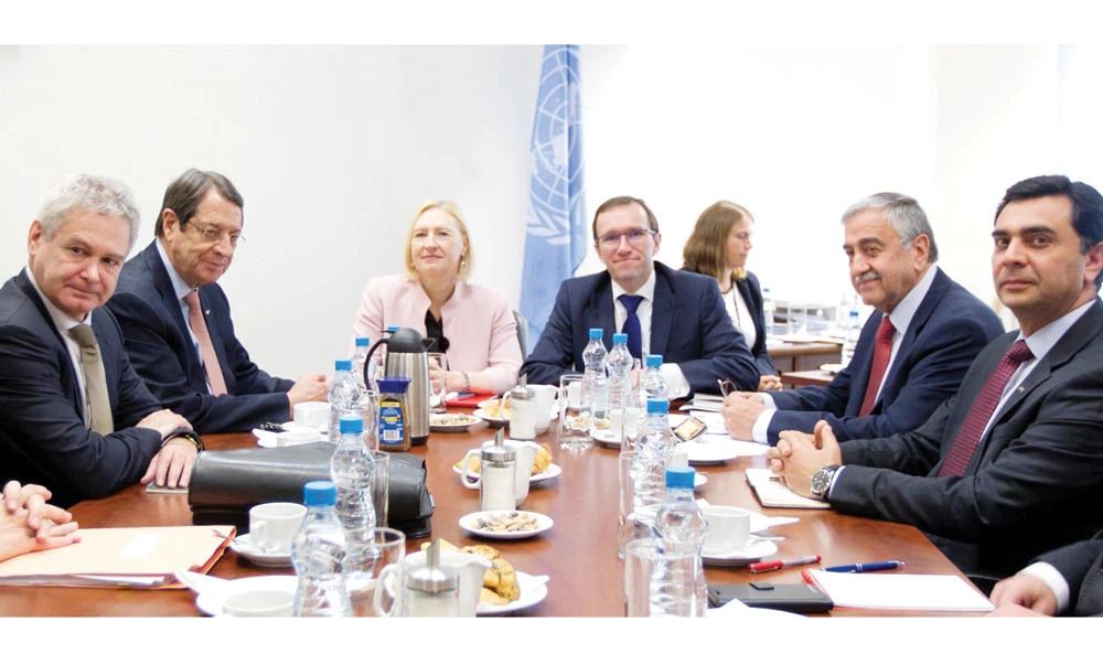 Cypriot President Nicos Anastasiades, 2nd left, meeting with his Turkish Cypriot counterpart Mustafa Akinci 2nd right, at Larnaca’s old airport, on Tuesday. (AFP)