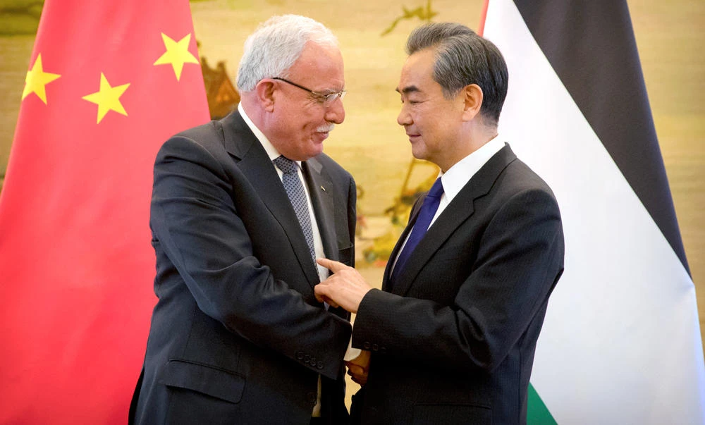 Palestinian Foreign Minister Riyad Al-Maliki, left, and Chinese Foreign Minister Wang Yi shake hands at the end of their joint press conference in Beijing on Thursday. (AP Photo/Mark Schiefelbein)