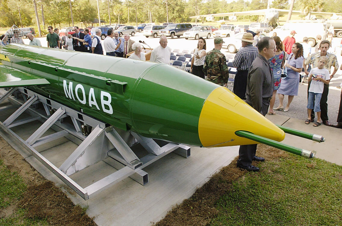 A group gathers around a GBU-43B, or massive ordnance air blast (MOAB) weapon, on display at the Air Force Armament Museum on Eglin Air Force Base. (AP)