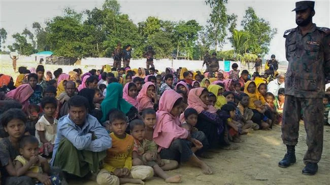 Rohingya Muslims from Myanmar, are kept under watch by Bangladeshi security officials in Teknaf on December 25, 2016. (AFP)