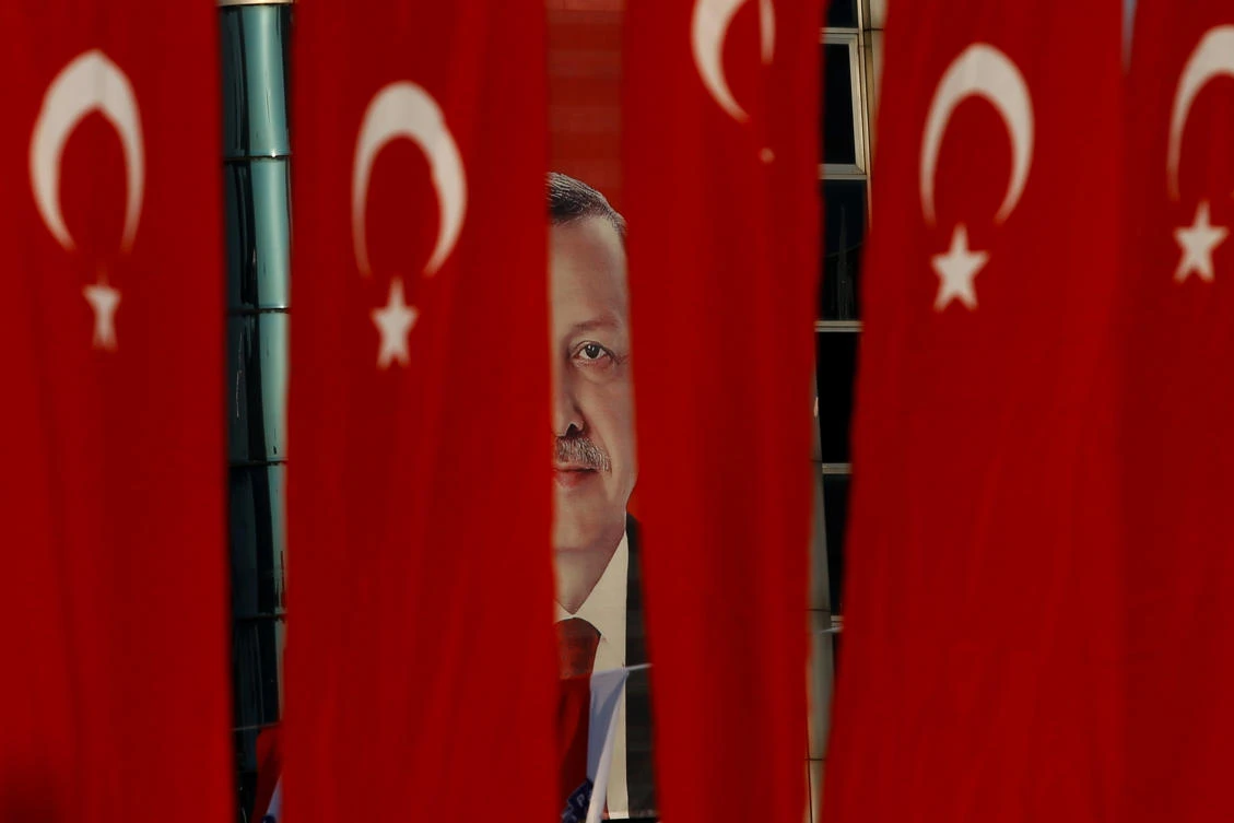 A picture of Turkish President Tayyip Erdogan is seen through Turkish national flags ahead of the constitutional referendum in Istanbul, Turkey (REUTERS)