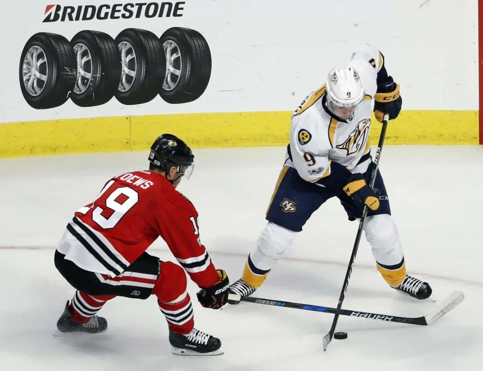 Chicago Blackhawks center Jonathan Toews (19) battles for the puck with Nashville Predators center Filip Forsberg (9) during the third period in game one of the first round of the Stanley Cup Playoffs at United Center on Thursday. (USA TODAY Sports)