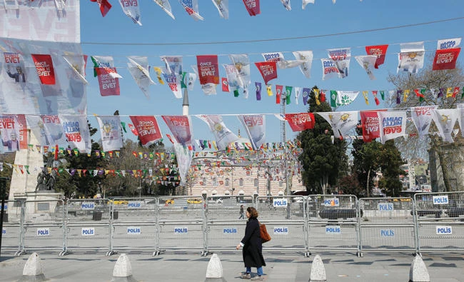 A woman walks past “Yes” banners for Sunday’s referendum, in Istanbul, on Friday. (AP)