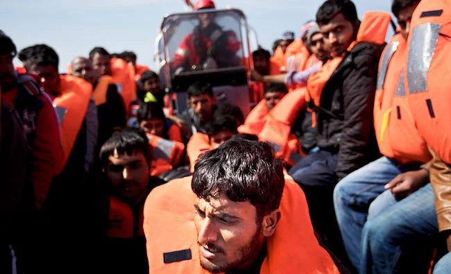 Migrants are rescued from a rubber boat by members of Proactiva Open Arms NGO, in the Mediterranean sea, about 56 miles north of Sabratha, Libya. (AP)