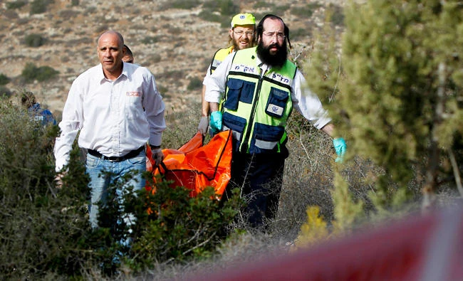 Israeli rescue workers carry the body of US tourist Kristine Luken. (AP)