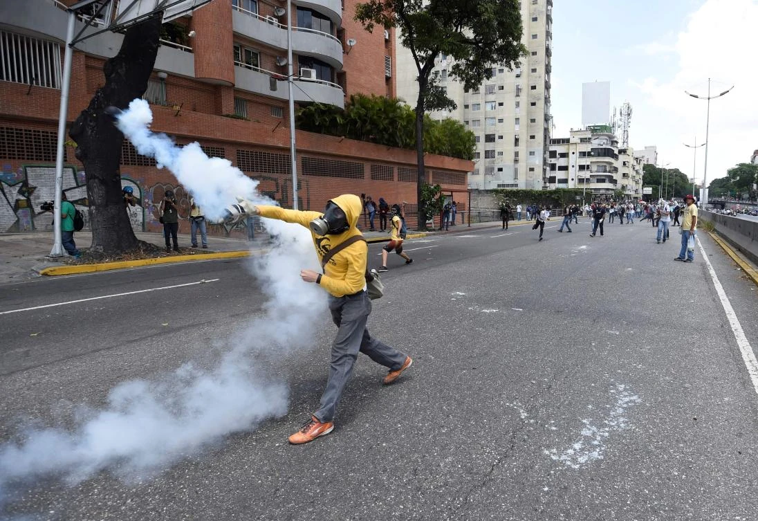 Demonstrators against Nicolas Maduro's government clash with riot police. (AFP)