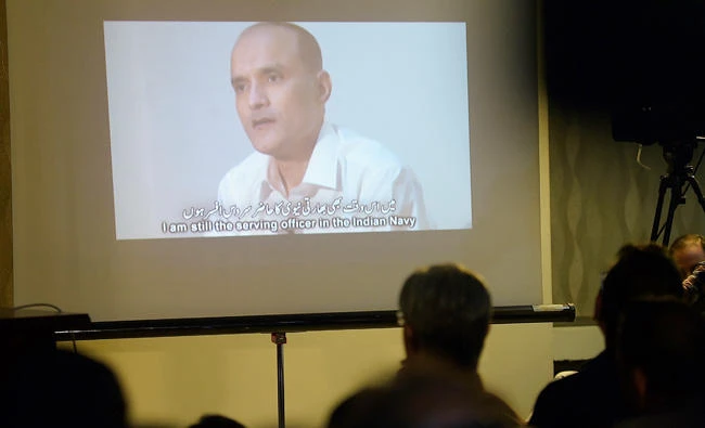 Pakistani journalists watch a video showing Indian national Kulbhushan Yadav, arrested on suspicion of spying. (AFP)