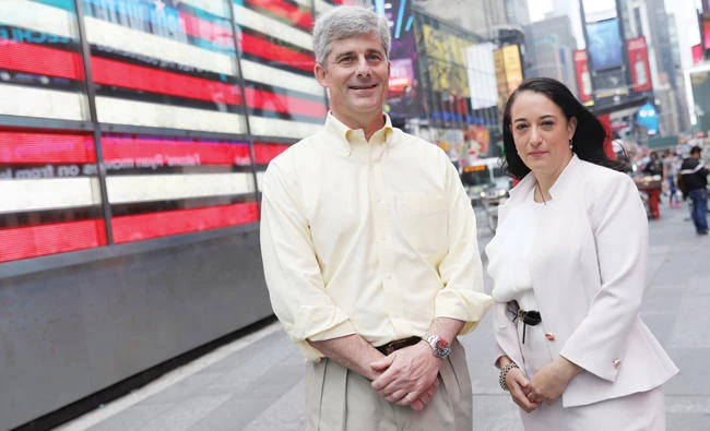 CEO of OceanGate Stockton Rush poses with Renata Rojas at Times Square in New York. (Reuters)