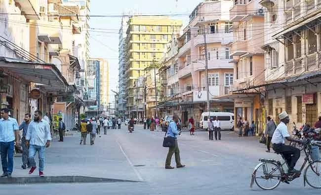 A man rides a bicycle as people walk in downtown Dar es Salaam, in this October 26, 2015 file photo. (AFP)