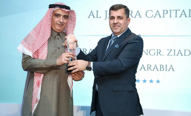 Ziad Tarek Aba Al-Khail, left, receives the award.