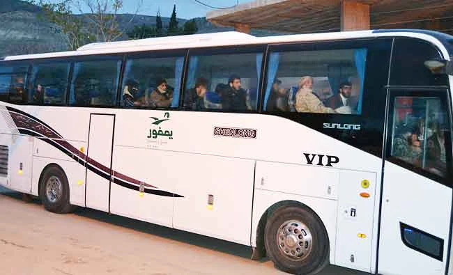 A bus carrying Syrian evacuees is seen in the rebel-held town of Madaya leaving under a deal brokered by opposition backer Qatar and regime ally Iran, on Friday. (AFP)