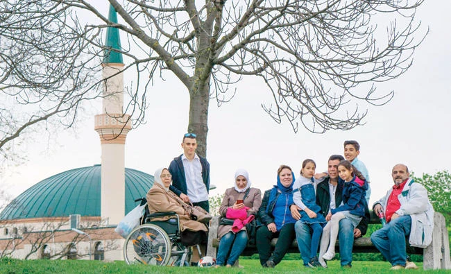 Austrian Muslims pose near a mosque in Vienna on Friday. (AFP)