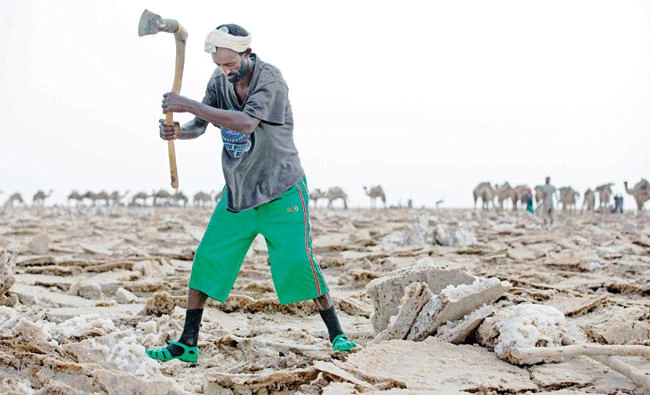 A man mines blocks of salt from the Danakil Depression in Afar, Ethiopia. (AFP)