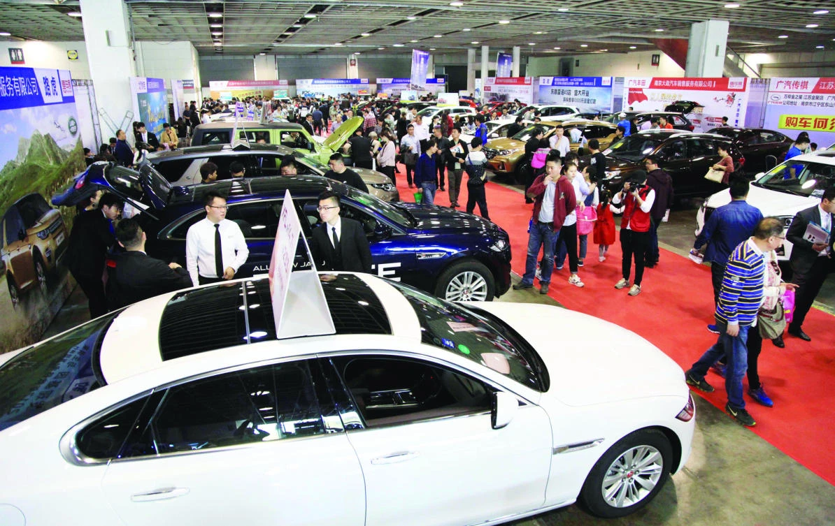People walk through an auto exhibition in Nanjing, in China's Jiangsu province on Saturday. (AFP)