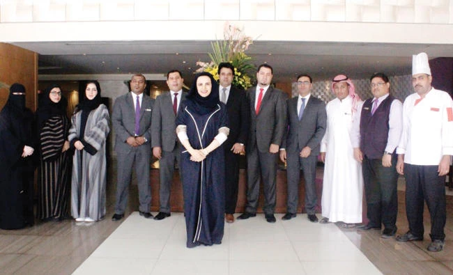 Hessa Al-Mazrou, general manager of Suite Novotel Hotel Riyadh, with hotel staff.