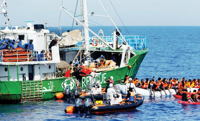 Rescue NGOs Sea-Eye and the Migrant Offshore Aid Station (MOAS) carry out a joint rescue operation in international waters off the coast of Libya, on Sunday. (Reuters)