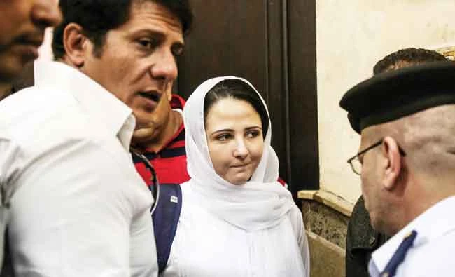 Aya Hijazi, center, a dual US-Egyptian citizen, speaks after her acquittal over accusations related to running a foundation dedicated to helping street children, in Cairo, on Sunday. (AP)