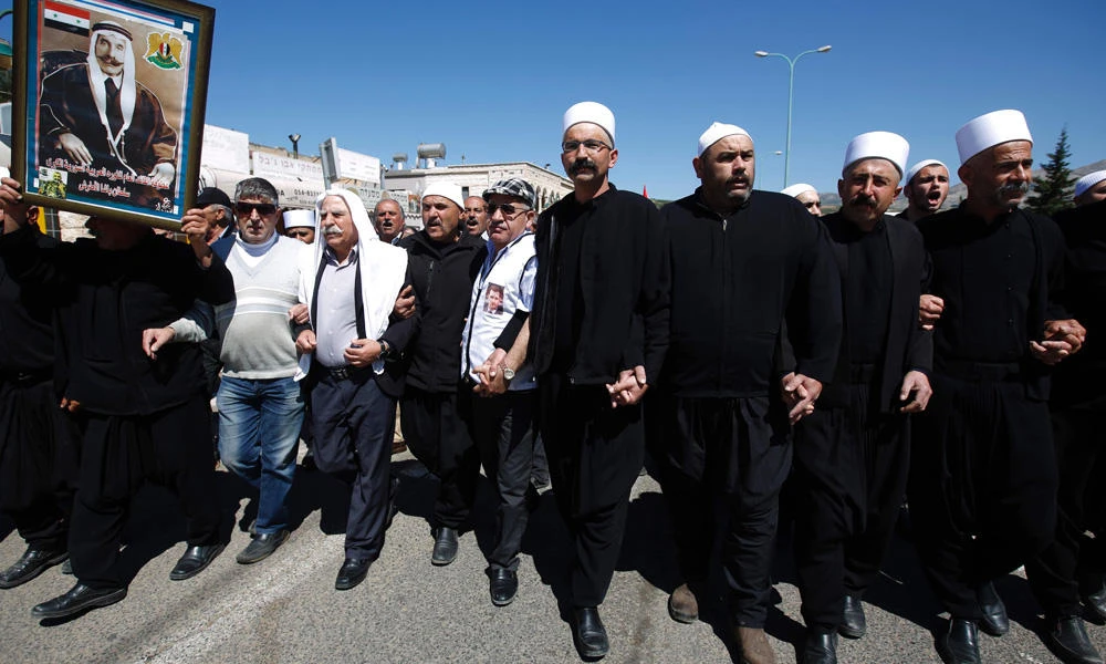 Druze residents of the Masada village in the Israeli-occupied Golan Heights take part in a rally marking Syria's Independence Day on April 17, 2017. (AFP / JALAA MAREY)