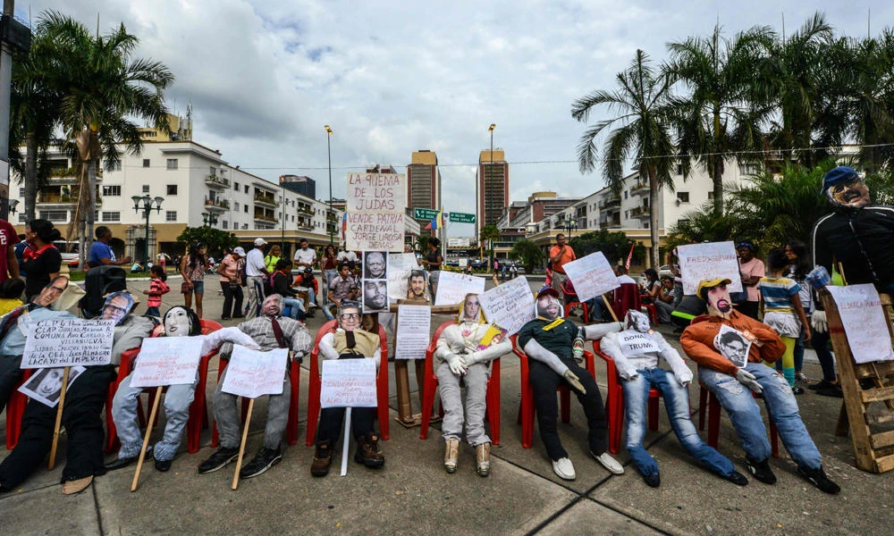 Dummies of the president of US President Donald Trump, the secretary general of the Organization of American States (OAS), and Venezuelan opposition leaders are readied for the "Burning of Judas" during an Easter celebration at El Silencio shantytown in Caracas on April 16, 2017. (AFP / FEDERICO PARRA)