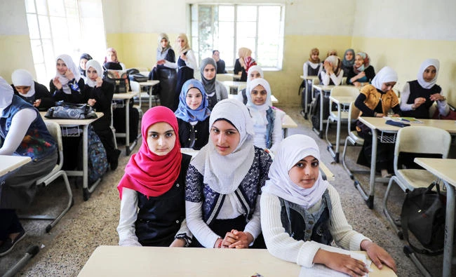 Pupils attend a class at an elementary school in eastern Mosul, Iraq, on Monday. (REUTERS)