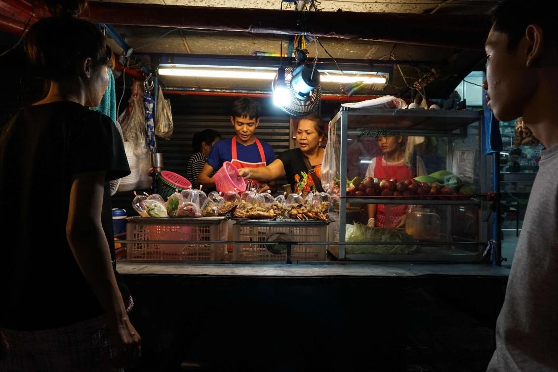 A family preparing food for customers at a street food stall in the Phrakanong district of Bangkok. (AFP)