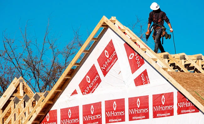 This file photo taken on March 8, 2017 shows a construction worker installing a rooftop on to a new home being built in Fairfax, Virginia. (AFP)