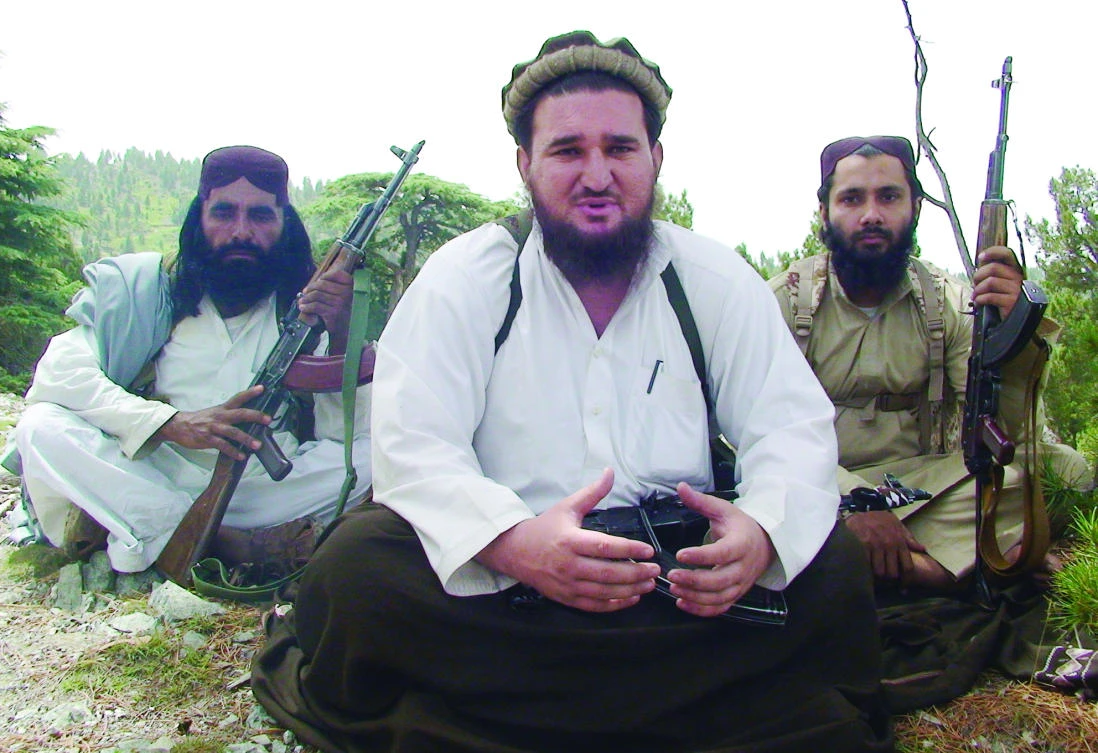 Ahsanullah Ahsan, center, talks to The Associated Press in the militant group’s stronghold of Shawal in Pakistani tribal region of South Waziristan in this Aug. 6, 2012 file photo. (AP)