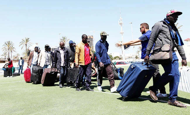 Illegal African migrants arrive at Mitiga International Airport before voluntary return to their countries, east of Tripoli, Libya, on Tuesday. (Reuters)