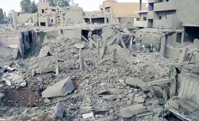 This image made from militant video posted online on Tuesday by the Aamaq News Agency, a media arm of the Islamic State group, purports to shows destroyed houses following a U.S.-led coalition strike in the eastern Syrian town of Boukamal, on the Iraqi border. (AP)
