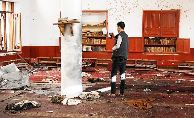 A man uses his mobile to take photos inside a mosque hit by two bombs in Sanaa, Yemen, in this file photo taken on Sept. 3, 2015. (AP)
